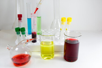 Laboratory chemical liquid elements and research diagnoses, instruments and objects in the sterile table, glassware and pipette.