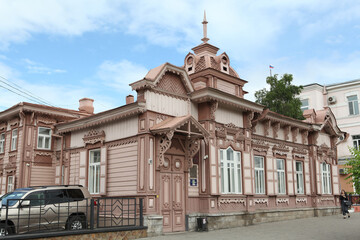 Vintage wooden Polutov's house with carved windows on Lenin Street, 100 in Chita city, Russia. Russian style in architecture. Chita landmark, monument. Chita sight, view © Sergey