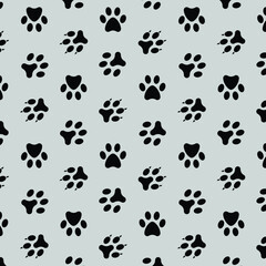 seamless vector pattern of black footprints of animals on white background