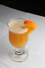 A close-up cocktail glass is on the table.