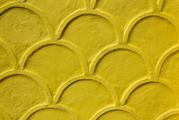Abstract yellow fluted ornament on the yellow wall of the house. Pattern of yellow on wall....