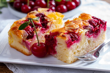 Fresh baked cake with red ripe juicy sour cherry or kriek berry
