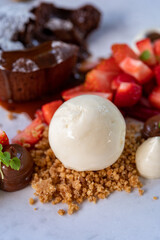 Tasty dessert, hot chocolate cake and vanilla ice cream with fresh strawberry