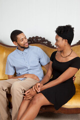 Romantic Black couple sitting on a couch
