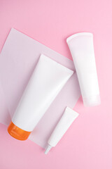 White cosmetic bottle isolated on pink background. Mock up for design. Template for cosmetic and medical.