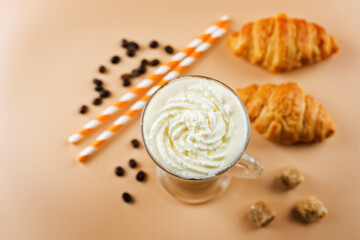 Coffee with whipped cream in a glass with coffee beans