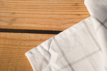 White plaid Towel on wooden table. Copy space. Dining background. Outdoor picnic 