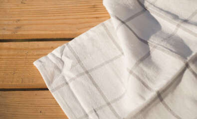 White plaid Towel on wooden table. Copy space. Dining background. Outdoor picnic 