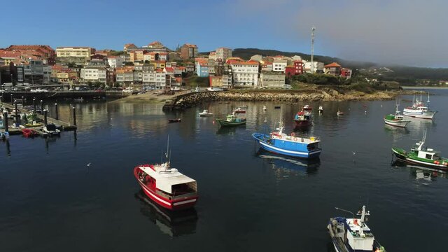 Boatds in harbour of Finisterre. Camino de Santiago. Coast of Galicia,Spain. Aerial Drone Footage