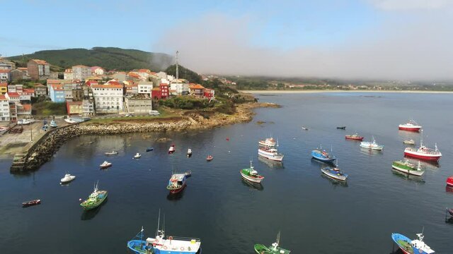 Boatds in harbour of Finisterre. Camino de Santiago. Coast of Galicia,Spain. Aerial Drone Footage