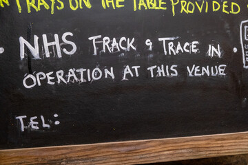 A handwritten sign at a pub about NHS track and trace as pubs and restaurants begin to open again as the covid lockdown eases in the UK