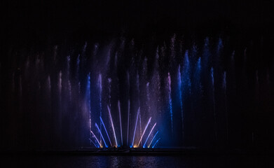 Musical multimedia fountain with colorful lights at night. Ukraine, Vinnitsa