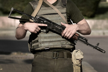 Soldier Military with weapon. Armed forces, troops, army. Soldier with    Kalashnikov assault rifle (AK-74)
