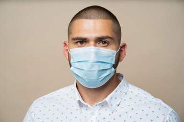 doctor with mask. A man in a protective mask looks at the camera