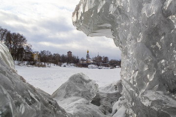 Cityscape of small russian town with block of ice in the foreground