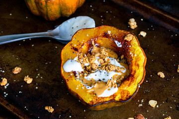 Healthy Acorn Squash Breakfast Bowl: Roasted acorn squash filled with yogurt, granola, almond butter, chia seeds, and hemp hearts