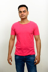Obraz premium Portrait of young handsome Indian man against white background