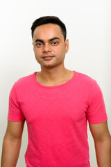 Obraz premium Portrait of young handsome Indian man against white background