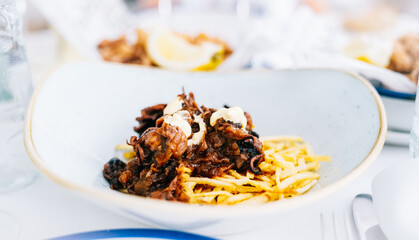 Delicious appetizer served on an elegant white plate in a restaurant.