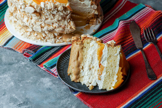 Uruguayan cake chaja: the famous sponge cake from Uruguay,  sponge cake stuffed with syrup, dulce de leche, whipped cream and peaches.