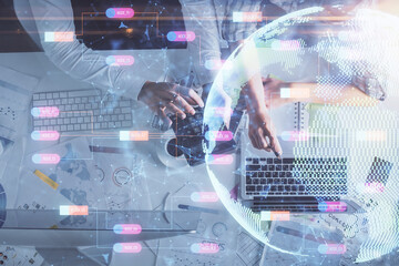 Double exposure of man and woman working together and world map hologram drawing. international network concept. Computer background. Top View.