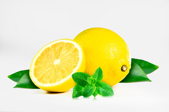 Fresh lemon with mint leaves, isolated on white background