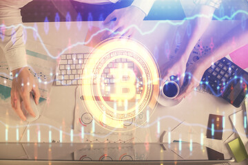 Double exposure of man and woman working together and crypto theme hologram drawing. Computer...