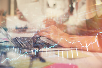 Multi exposure of woman hands typing on computer and financial graph hologram drawing. Stock market analysis concept.