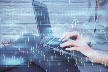 Multi exposure of woman hands typing on computer and forex chart hologram drawing. Stock market analysis concept.