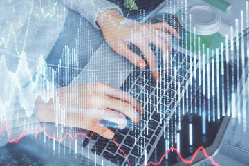 Double exposure of woman hands typing on computer and forex chart hologram drawing. Stock market invest concept.