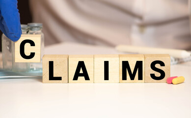 claims word written on wood block. claims text on wooden table for your desing, concept.