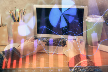 Double exposure of woman hands typing on computer and forex chart hologram drawing. Stock market invest concept.