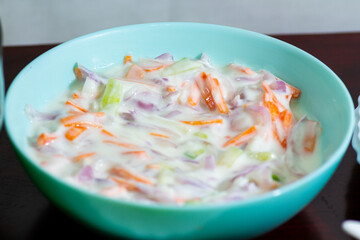 Raita or salad is an Indian based yogurt mixed with onions, coriander or cucumber.