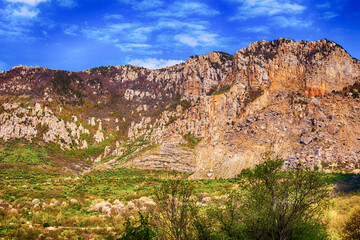mountain brown high inaccessible sunlight on a background of blue sky walk hollow