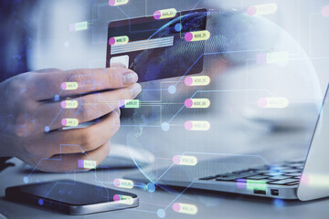 Double exposure of woman on-line shopping holding a credit card and data theme hologram drawing. E-commerce concept.
