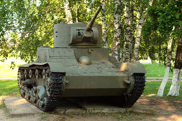 Old tank under the trees, participated in the 2nd world war.