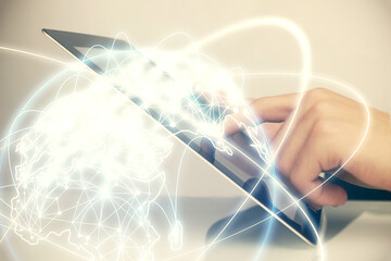 Double exposure of man's hands holding and using a phone and international business theme drawing.