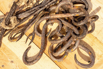 heap sharp metal hook forged rusty closeup many products background