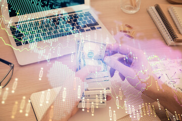Multi exposure of financial graph drawing hologram and USA dollars bills and man hands. Analysis concept.
