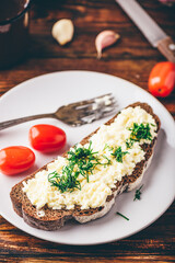 Rye bread toast with processed cheese, garlic and dill