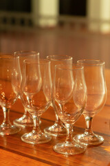 transparent wine glasses, a set for wine tasting stands on a wooden table