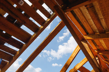 old roof renovation, frame of the roof against blue sky background
