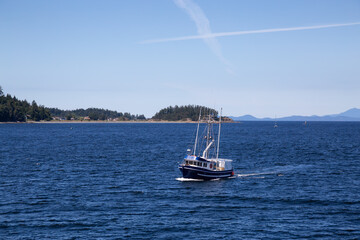 Boat in the Ocean by the City of Nanaimo during a sunny summer day. Taken in Vancouver Island, British Columbia, Canada.
