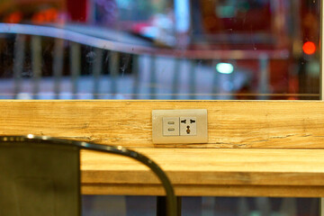 Wall socket on the cafe table.