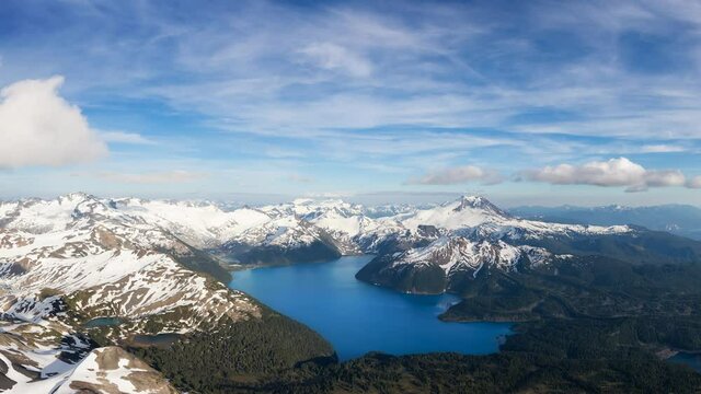 Cinemagraph Continuous Loop Animation. Aerial Panoramic View of Garibaldi surrounded by Canadian Mountain Landscape during a sunny and cloudy day. Taken near Squamish, North of Vancouver, BC, Canada.