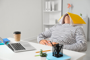 Tired student sleeping at table