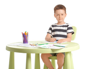 Cute little boy coloring pictures on white background