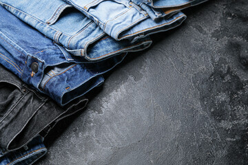 Stylish jeans pants on dark background