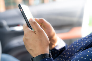 Holding and use smart mobile phone to communication at outdoor.