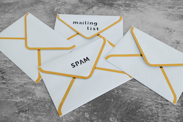 inbox organization concept, group of email envelopes with labels for spam and mailing list content